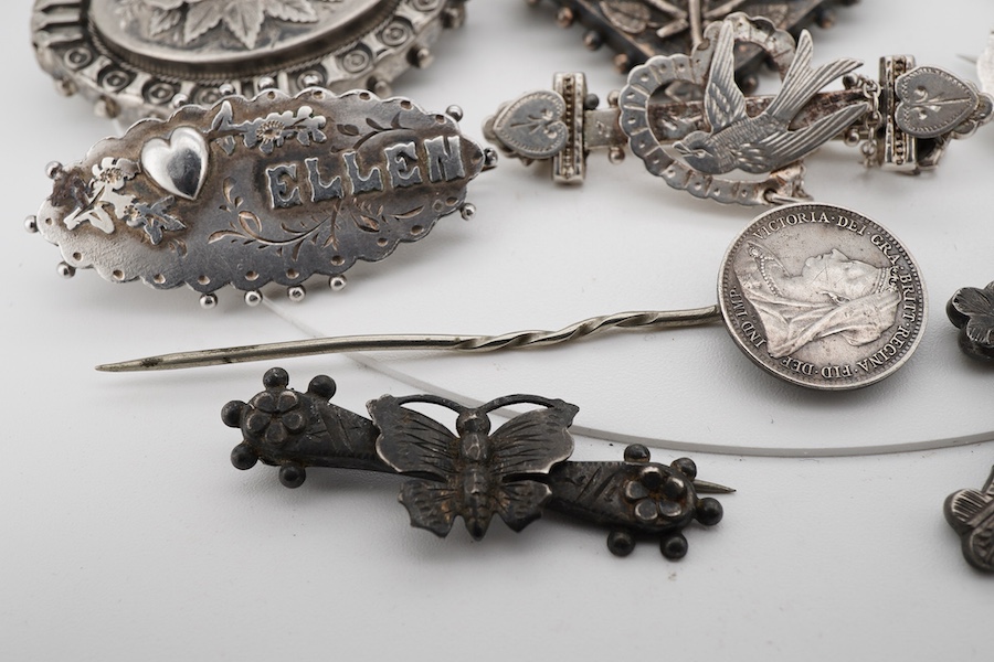 Ten assorted late 19th/early 20th century silver brooches, including three with names, Baby, Millicent and Ellen, together with five other white metal brooches including Scottish hardstones, a coin set stick pin, hardsto